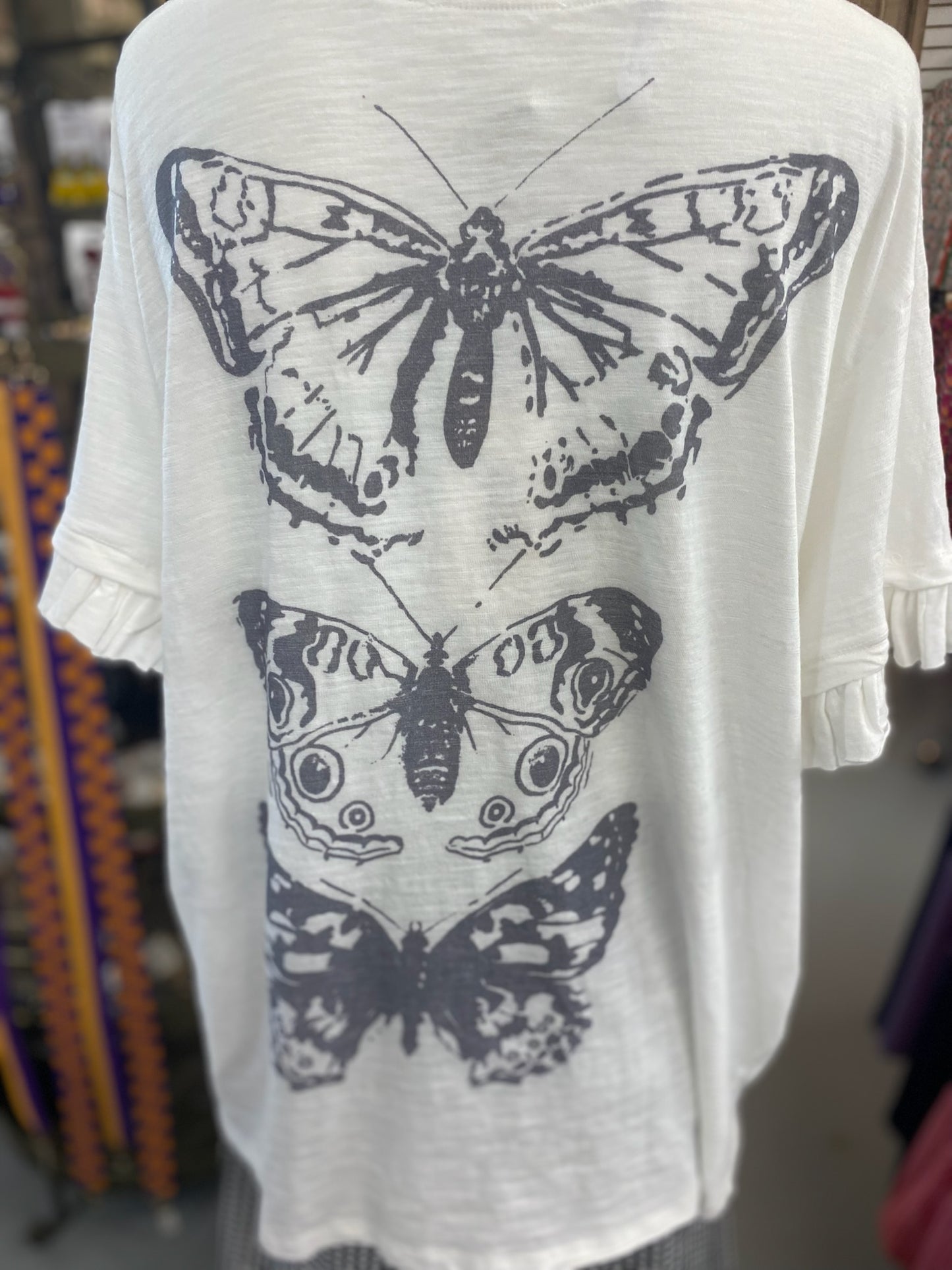 Ruffle Butterfly Top with distressing on the shoulders and pockets