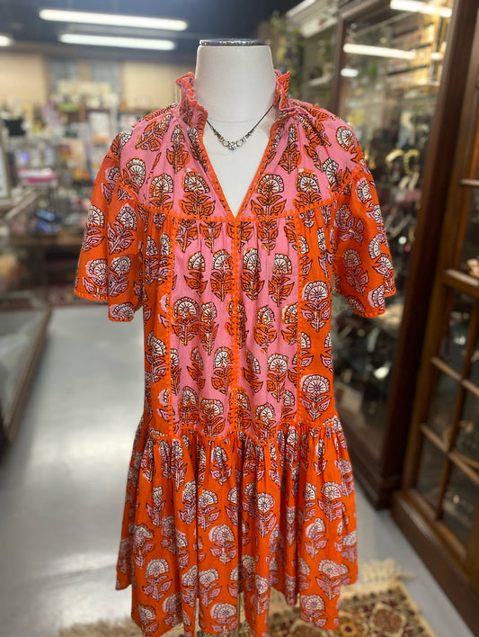 orange and pink block print cotton dress with ruffle hem and floral pattern