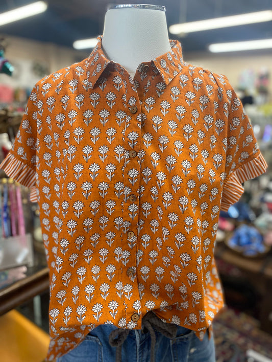 burnt orange short sleeve floral button down top with striped cuffs