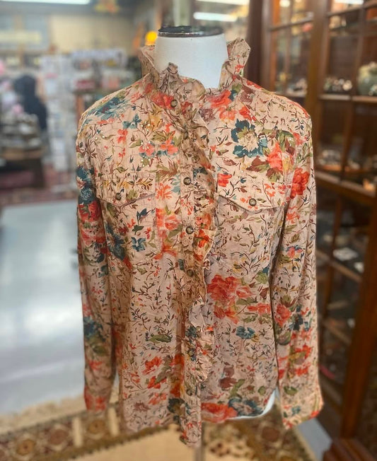 Floral eyelet cotton snap shirt with ruffle neckline on mannequin.