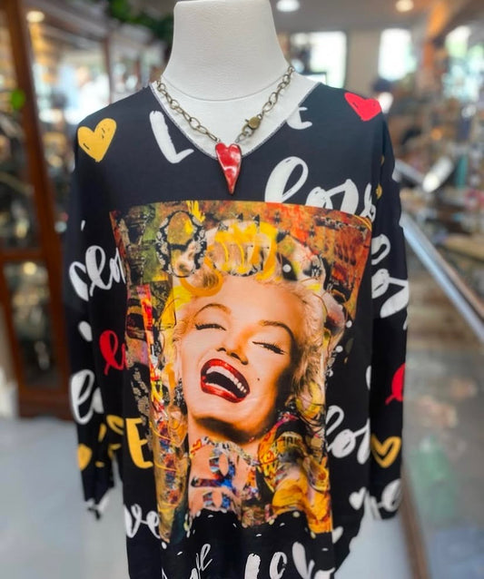 black cotton graphic top featuring Marilyn Monroe artwork with colorful accents displayed on mannequin