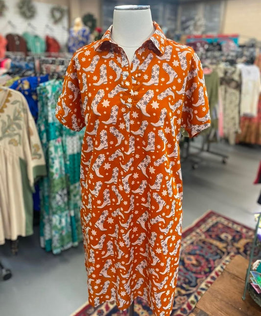 orange cotton shirt dress with cowboy boot print displayed on mannequin