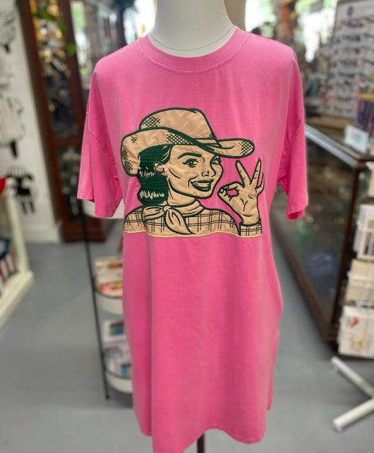 pink T-shirt dress featuring embroidered cowgirl graphic displayed on mannequin