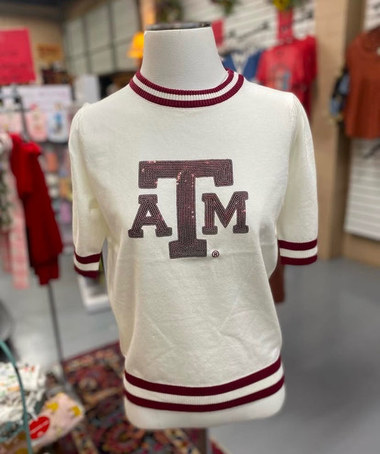 cream lightweight sweater top with maroon Texas A&M logo and striped accents displayed on mannequin